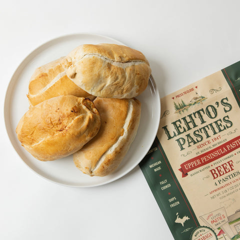 Lehto's pasties on a white plate beside a four-pasty bag of Lehto's Beef Pasties.
