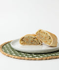 A Lehto's chicken pasty cut in half on a white plate, showing the chicken and vegetable filling.