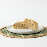 A Lehto's chicken pasty cut in half, showing the chicken and vegetable filling inside the golden crust.