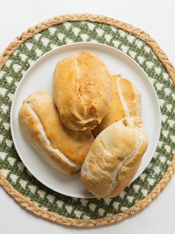 Four golden Lehto's pasties on a white plate.